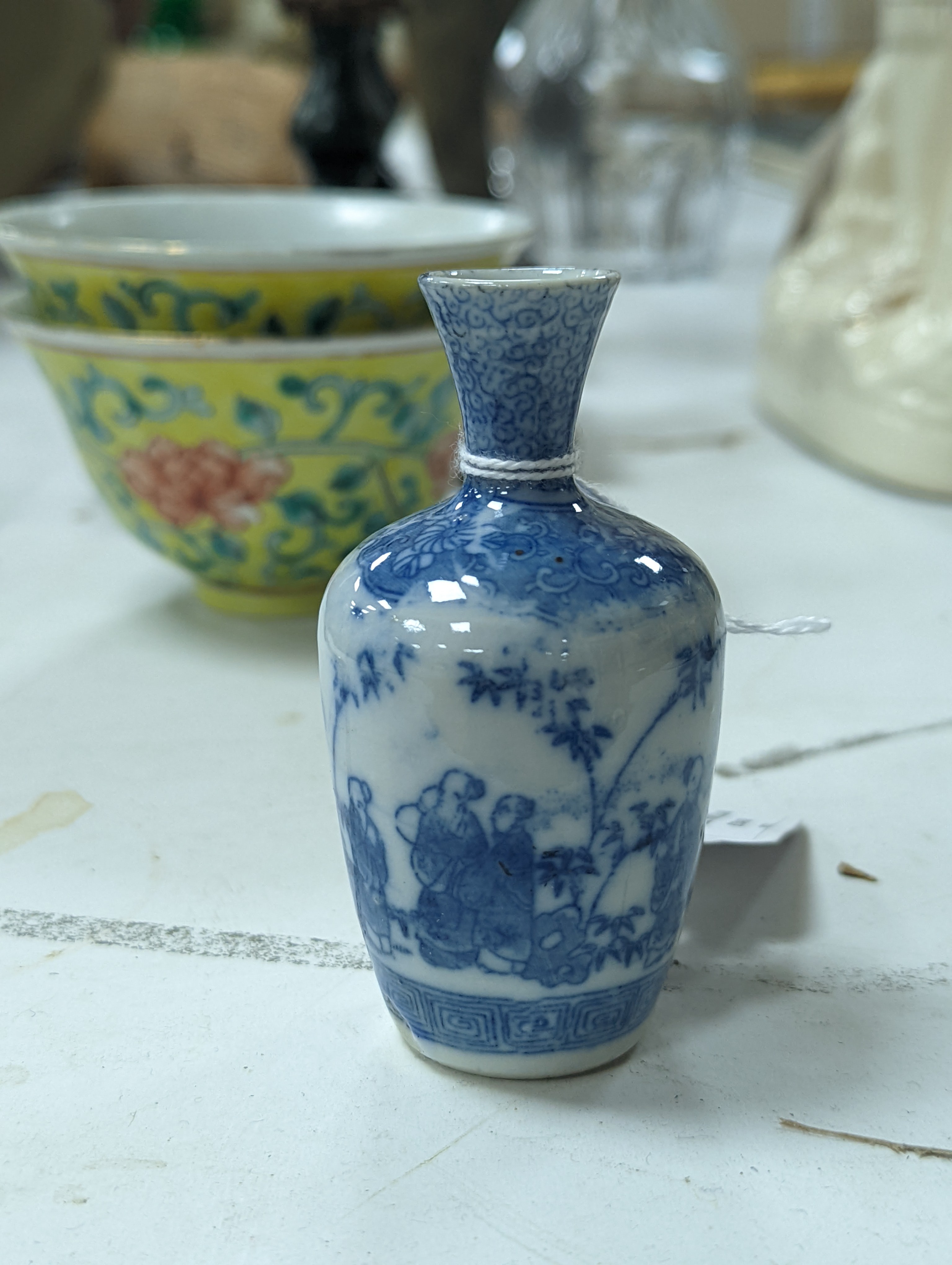 A group of Chinese porcelain, 19th /20th century, to include a pair of yellow ground bowls, 10.8 cm diameter, a blue and white vase, Xuande mark, a similar bowl and vase, and a champleve enamel bronze koro and cover